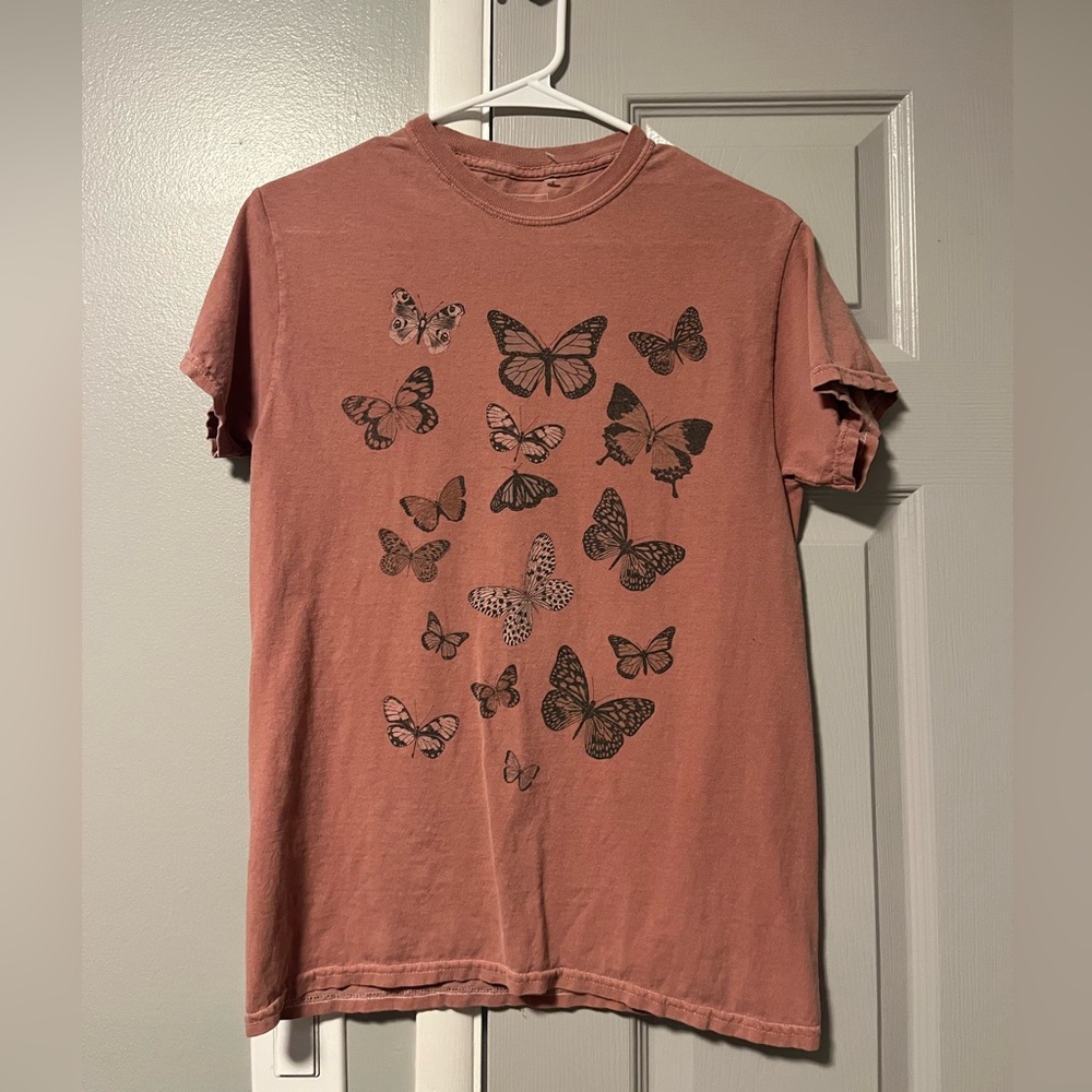 Light pink tee shirt with butterfly’s